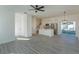 Bright living room featuring an open kitchen concept, pendant lighting, and sleek wood floors at 1307 E Harding St, Orlando, FL 32806