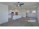 Bright and airy living room featuring an open kitchen concept with modern appliances, fixtures, and wood floors at 1307 E Harding St, Orlando, FL 32806