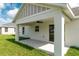 Covered back porch with ceiling fan and access door enhances outdoor living at 13334 Sw 107 St, Dunnellon, FL 34432
