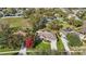 Aerial view of home with mature trees, vibrant landscaping, and a spacious lawn at 13753 Via Roma Cir, Clermont, FL 34711