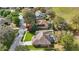 Aerial view of a home with a screened pool, mature trees and verdant landscaping at 13753 Via Roma Cir, Clermont, FL 34711