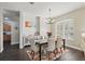 Elegant dining room with hardwood floors, chandelier, and stylish furnishings at 13753 Via Roma Cir, Clermont, FL 34711