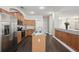 Modern kitchen featuring stainless steel appliances, granite countertops, and ample cabinet space at 13753 Via Roma Cir, Clermont, FL 34711