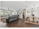 Open-concept living area with hardwood floors, dining area, and large windows at 13753 Via Roma Cir, Clermont, FL 34711