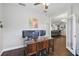 Home office with dark wood desk, hardwood floors, and open access to other rooms at 13753 Via Roma Cir, Clermont, FL 34711