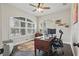 Bright home office featuring dark hardwood floors and large windows with plantation shutters at 13753 Via Roma Cir, Clermont, FL 34711