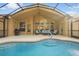 Inviting screened-in pool and lounge area with comfortable outdoor seating at 13753 Via Roma Cir, Clermont, FL 34711