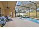 Screened-in pool and patio area with seating, great for outdoor entertaining at 13753 Via Roma Cir, Clermont, FL 34711