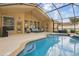 Inviting screened-in pool area with comfortable seating and clear blue water at 13753 Via Roma Cir, Clermont, FL 34711