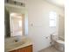 Standard bathroom with a toilet, sink, shower/tub combo, and mirror at 13828 Se 85Th Cir, Summerfield, FL 34491