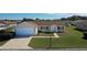 Well maintained single-story home featuring an attached garage and manicured lawn at 13828 Se 85Th Cir, Summerfield, FL 34491