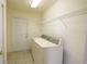 Functional laundry room with washer, dryer, and a door at 13828 Se 85Th Cir, Summerfield, FL 34491