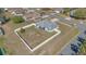 Aerial view of home with fenced backyard and sidewalk access on corner lot surrounded by neighborhood at 1391 Willow Crest Dr, Clermont, FL 34711