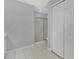 Well lit bathroom with a glass enclosed shower, white tile flooring, and white walls at 1391 Willow Crest Dr, Clermont, FL 34711