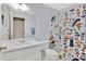 Bathroom featuring a large mirror and a shower curtain with cartoon characters at 1391 Willow Crest Dr, Clermont, FL 34711