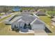 Aerial view of a well-maintained home featuring a manicured lawn and mature landscaping at 1391 Willow Crest Dr, Clermont, FL 34711
