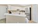 Well-lit kitchen with white cabinets, breakfast bar, and stainless steel appliances for modern convenience at 1391 Willow Crest Dr, Clermont, FL 34711