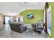 Open-concept living room featuring wood floors, green accent walls, and ample natural light at 1391 Willow Crest Dr, Clermont, FL 34711