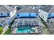 Aerial view of the home's backyard and private screened-in pool with a manicured lawn in a residential neighborhood at 1524 Flange Dr, Davenport, FL 33896