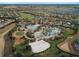 Aerial view of community featuring multiple pools, clubhouse, and residential homes, set in a beautifully landscaped environment at 1524 Flange Dr, Davenport, FL 33896