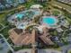 Aerial view of community pool area with multiple pools, splashpad, and landscaped surroundings at 1524 Flange Dr, Davenport, FL 33896