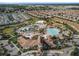 Aerial view of the community with a pool, splash pad, landscaping, and residential homes, offering a comprehensive perspective at 1524 Flange Dr, Davenport, FL 33896