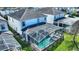 Aerial view of the home's backyard featuring a screened-in pool, manicured lawn, and proximity to neighboring properties at 1524 Flange Dr, Davenport, FL 33896