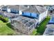 Aerial view of the backyard featuring a screened-in pool and manicured lawn, showcasing the home's outdoor amenities at 1524 Flange Dr, Davenport, FL 33896