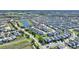 A birds eye view displays the neighborhood with community pond and manicured green spaces at 1524 Flange Dr, Davenport, FL 33896
