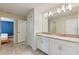 Well-lit bathroom showcasing a double sink vanity and neutral ceramic tile floors at 1524 Flange Dr, Davenport, FL 33896