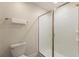 Bathroom featuring a walk-in shower with glass door, toilet, and towel rack at 1524 Flange Dr, Davenport, FL 33896