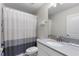 Bathroom featuring a shower/tub combo with a gray and white shower curtain and a white sink at 1524 Flange Dr, Davenport, FL 33896