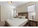 Comfortable bedroom with a queen bed, bedside tables, lamps, and two large windows that provide natural light at 1524 Flange Dr, Davenport, FL 33896