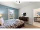 Tastefully decorated bedroom with queen bed, bedside lamps, a TV, a dresser, and a view to the hallway at 1524 Flange Dr, Davenport, FL 33896