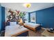 Themed bedroom featuring twin beds and vibrant Marvel-themed wall art, creating a fun and imaginative space at 1524 Flange Dr, Davenport, FL 33896