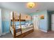 Bedroom features a cozy bunk bed, with half blue walls, and an ensuite bathroom with a modern shower at 1524 Flange Dr, Davenport, FL 33896