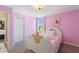 Pink princess-themed bedroom featuring a unique crown-shaped headboard and a bright, cheerful ambiance at 1524 Flange Dr, Davenport, FL 33896