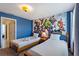 Twin beds with Marvel-themed wallpaper create a playful, vibrant space for children or guests at 1524 Flange Dr, Davenport, FL 33896