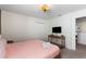Bedroom featuring a bed, a TV on the wall, and an open doorway at 1524 Flange Dr, Davenport, FL 33896