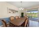 Bright dining room overlooking the pool area, enhanced by a classic chandelier and neutral decor at 1524 Flange Dr, Davenport, FL 33896