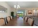 Dining room with a view of the pool through sliding glass doors, complemented by a stylish chandelier at 1524 Flange Dr, Davenport, FL 33896