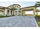 Community clubhouse entrance with palm trees, lush landscaping, and elegant architecture at 1524 Flange Dr, Davenport, FL 33896