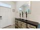Bright entryway featuring tile flooring, a decorative console table, mirror and a white front door at 1524 Flange Dr, Davenport, FL 33896