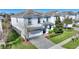 Charming two-story home with a well-manicured lawn and a paved driveway leading to an attached two-car garage at 1524 Flange Dr, Davenport, FL 33896