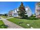 View of a two-story white home, lush green lawn, and manicured landscaping at 1524 Flange Dr, Davenport, FL 33896