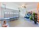 Spacious garage with ping pong table, recreational seating and room to park vehicles, a versatile space at 1524 Flange Dr, Davenport, FL 33896