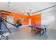 Finished garage, painted with vibrant colors, and plenty of space for recreational activities like ping pong at 1524 Flange Dr, Davenport, FL 33896