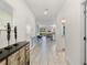 Open hallway featuring tile floors and neutral color scheme; dining and living spaces are at the end of the hall at 1524 Flange Dr, Davenport, FL 33896