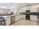 Modern kitchen features white cabinets, stainless steel appliances, and an open layout at 1524 Flange Dr, Davenport, FL 33896