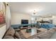 Open-concept living room with modern lighting and a seamless transition to the kitchen, perfect for entertaining at 1524 Flange Dr, Davenport, FL 33896